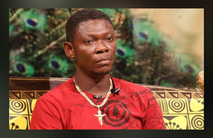 Agya Koo receives a heavy 