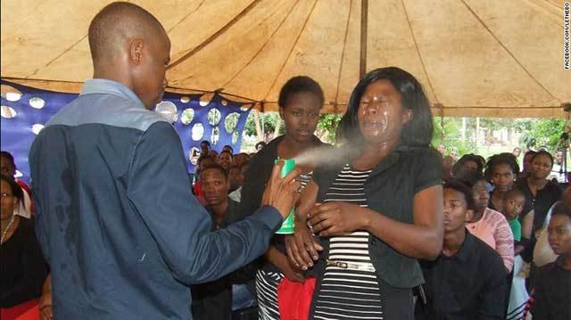 South African aastor Lethebo Rabalago spraying insecticide into his congregants faces. 